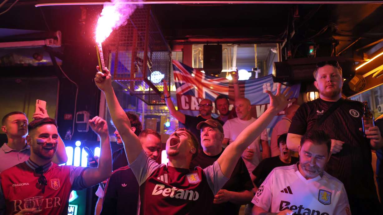 Aston Villa fans light flares and chant as they gather in the streets of Istanbul, Turkey, Tuesday, May 19, 2026, ahead of the Europa League final soccer match between Freiburg and Aston Villa.