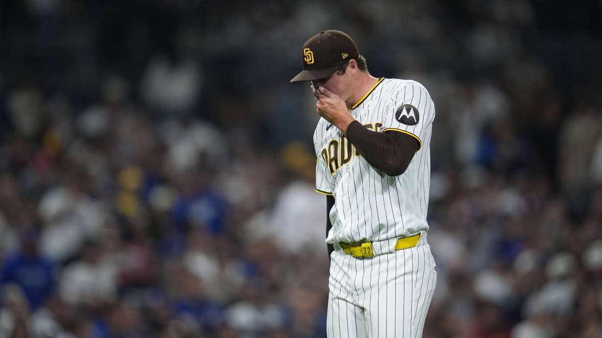 San Diego Padres pitcher Mason Miller reacts after giving up a sacrifice fly during the ninth inning of a baseball game against the Los Angeles Dodgers Tuesday, May 19, 2026, in San Diego.