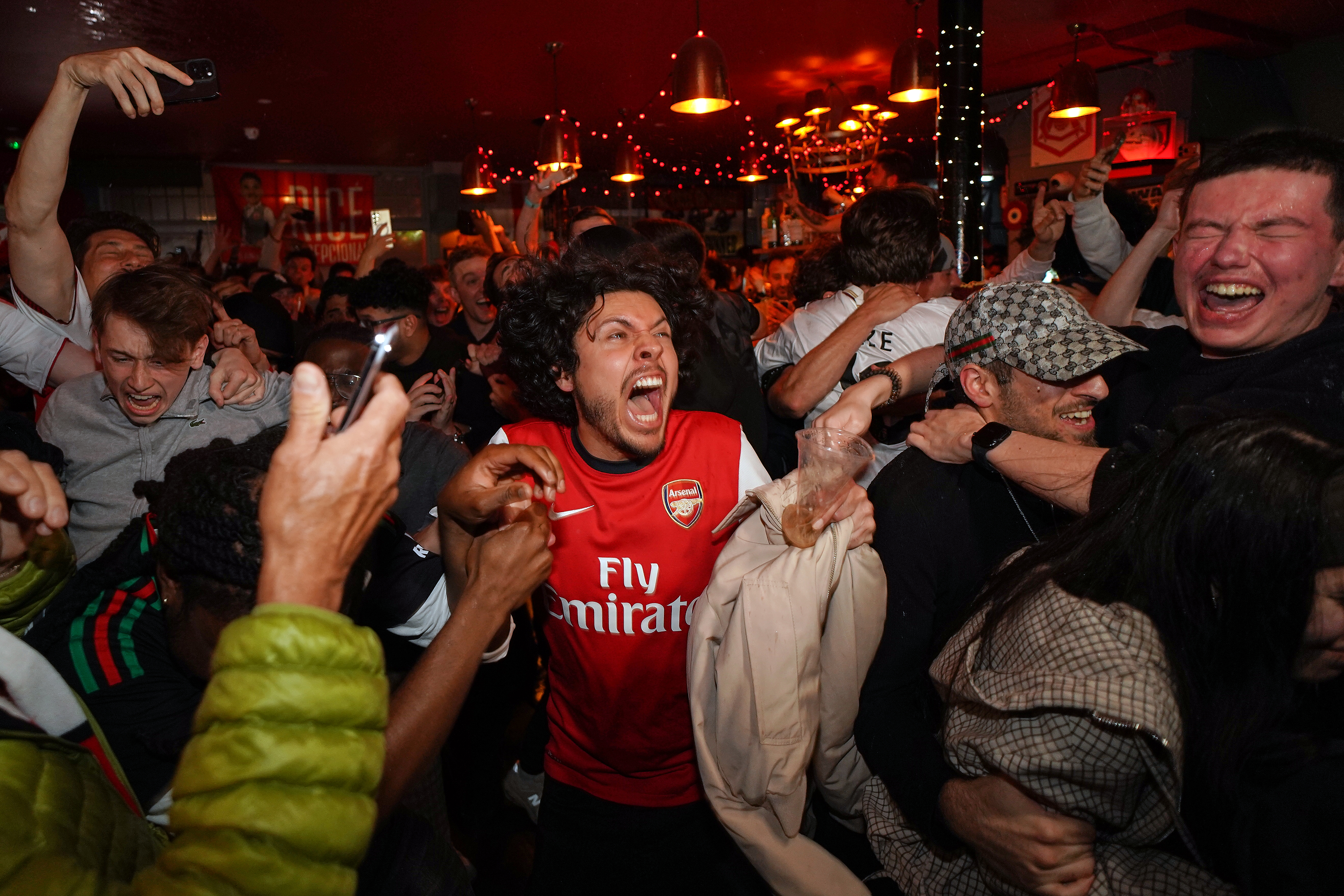 Arsenal supporters celebrate in a pub near the Arsenal stadium after Arsenal's soccer team won the Premier League title in London, Tuesday, May 19, 2026.