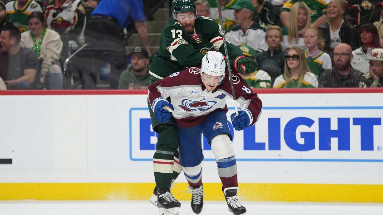Minnesota Wild center Yakov Trenin (13) pushes Colorado Avalanche defenseman Cale Makar (8) during the first period of Game 4 in a second-round NHL hockey Stanley Cup playoff series Monday, May 11, 2026, in St. Paul, Minn.