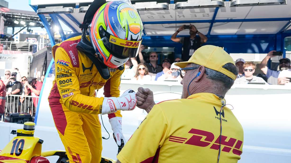 Alex Palou, of Spain, celebrates with a member of his crew during qualifications for the Indianapolis 500 auto race at the in Indianapolis, Sunday, May 17, 2026.