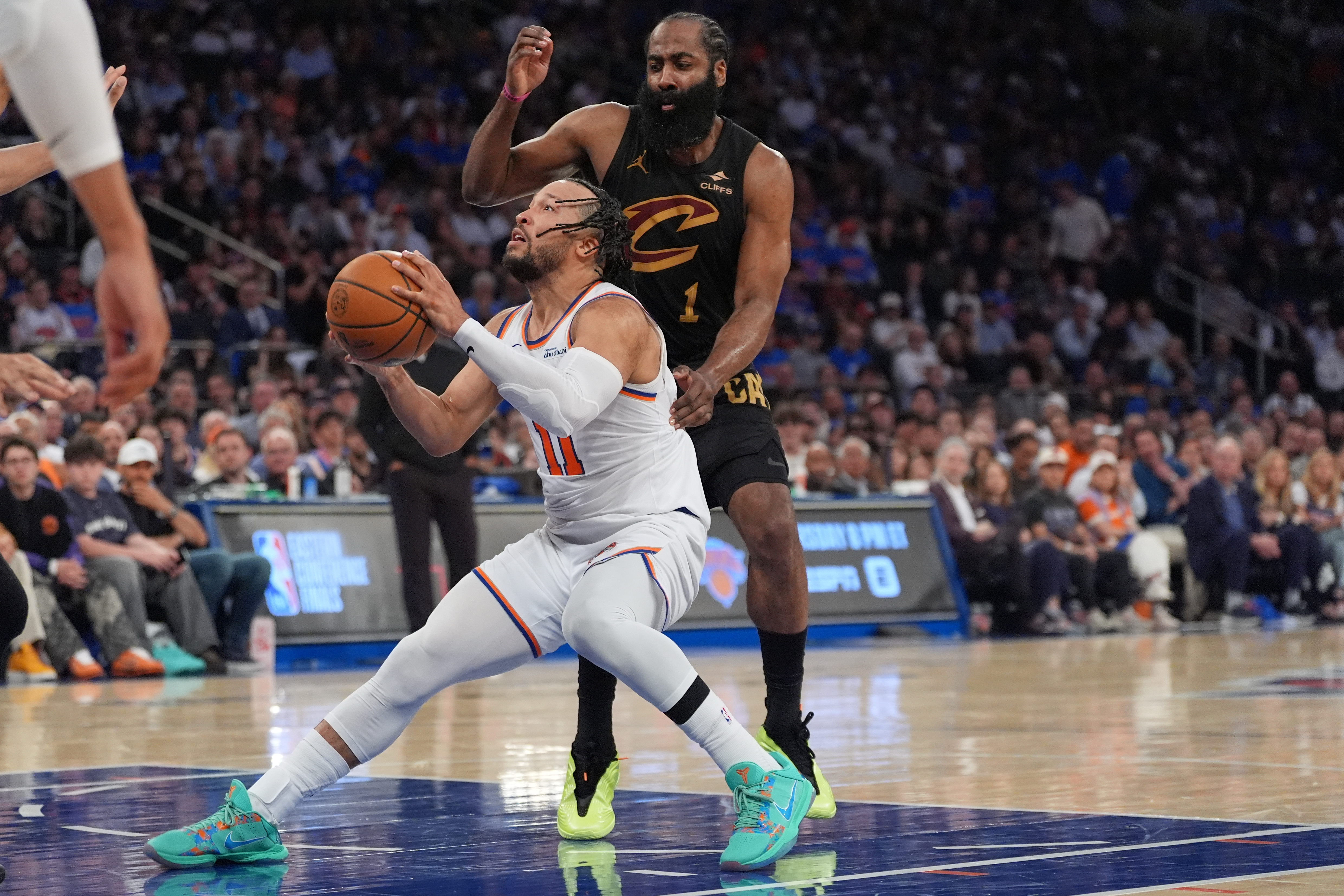 New York Knicks' Jalen Brunson, bottom, drives past Cleveland Cavaliers' James Harden during the second half of Game 1 in the Eastern Conference finals NBA basketball playoffs series Tuesday, May 19, 2026, in New York. 