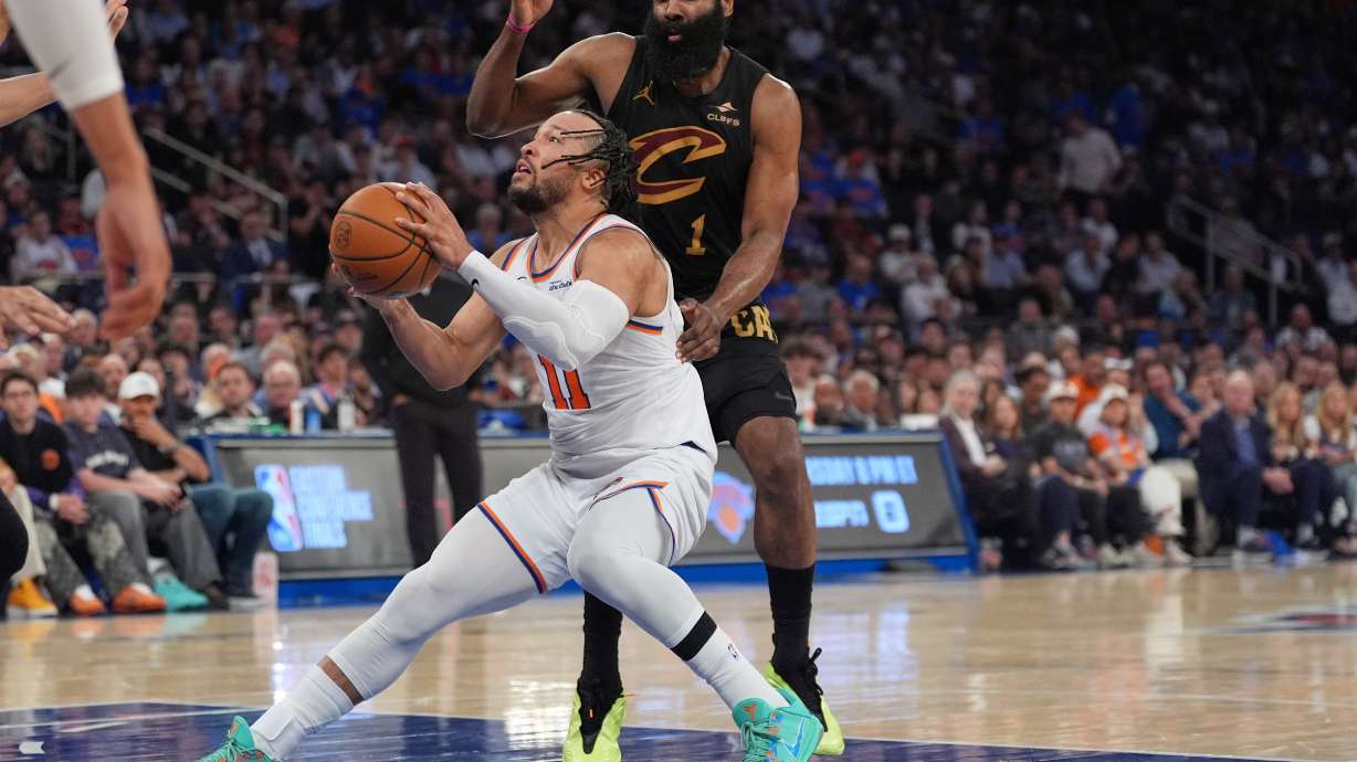 New York Knicks' Jalen Brunson, bottom, drives past Cleveland Cavaliers' James Harden during the second half of Game 1 in the Eastern Conference finals NBA basketball playoffs series Tuesday, May 19, 2026, in New York.