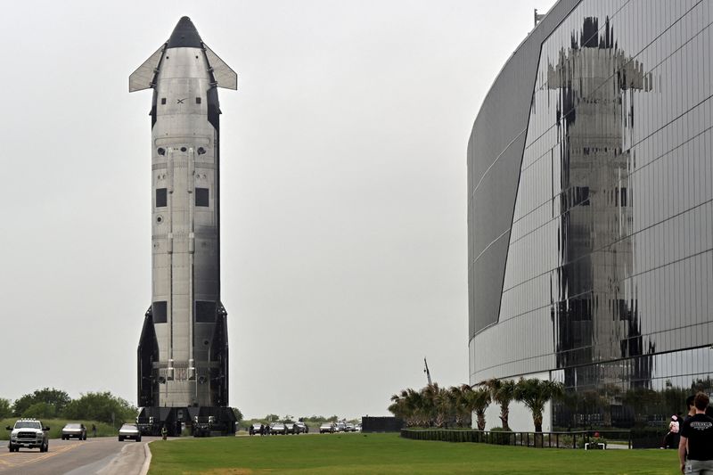 The SpaceX Starship spacecraft rolls past the production facility toward launch pad 2 ahead of its 12th test flight, in Starbase, Texas, Tuesday. The test flight is expected later this week after SpaceX unveiled an initial public offering filing on Wednesday.
