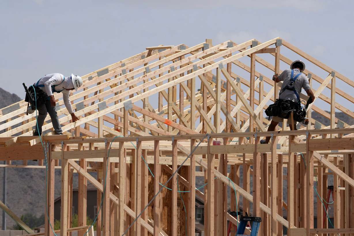 Construction workers frame up a roof of wood lumber at a new home build, April 1, 2025, in Laveen, Ariz. House prices remain on the rise, though Redfin reported on Wednesday that home price reductions are falling — though it isn't happening as often.
