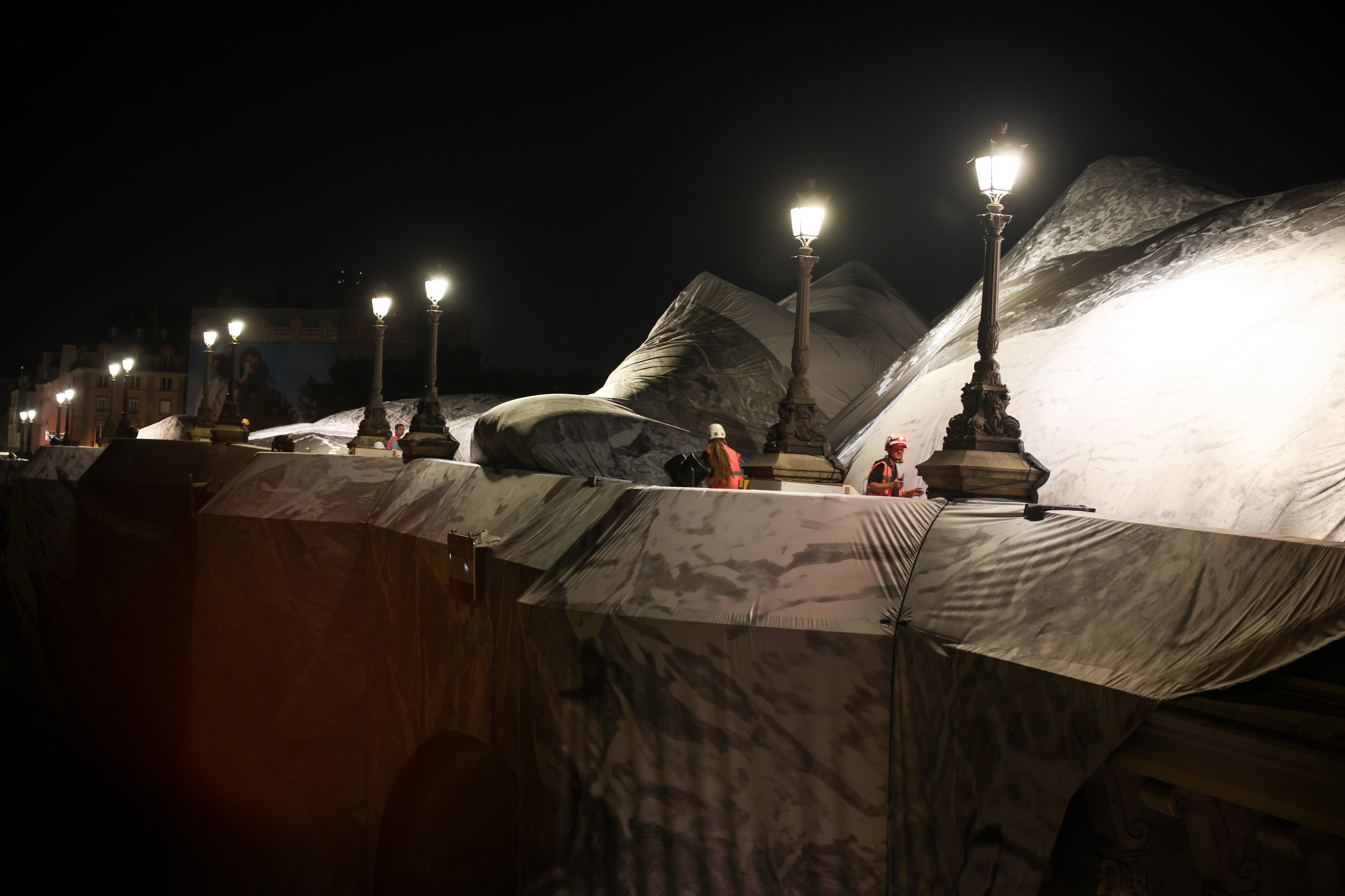 Artist JR, the 'French Banksy' creates a 'cave' installation over Paris' oldest bridge
