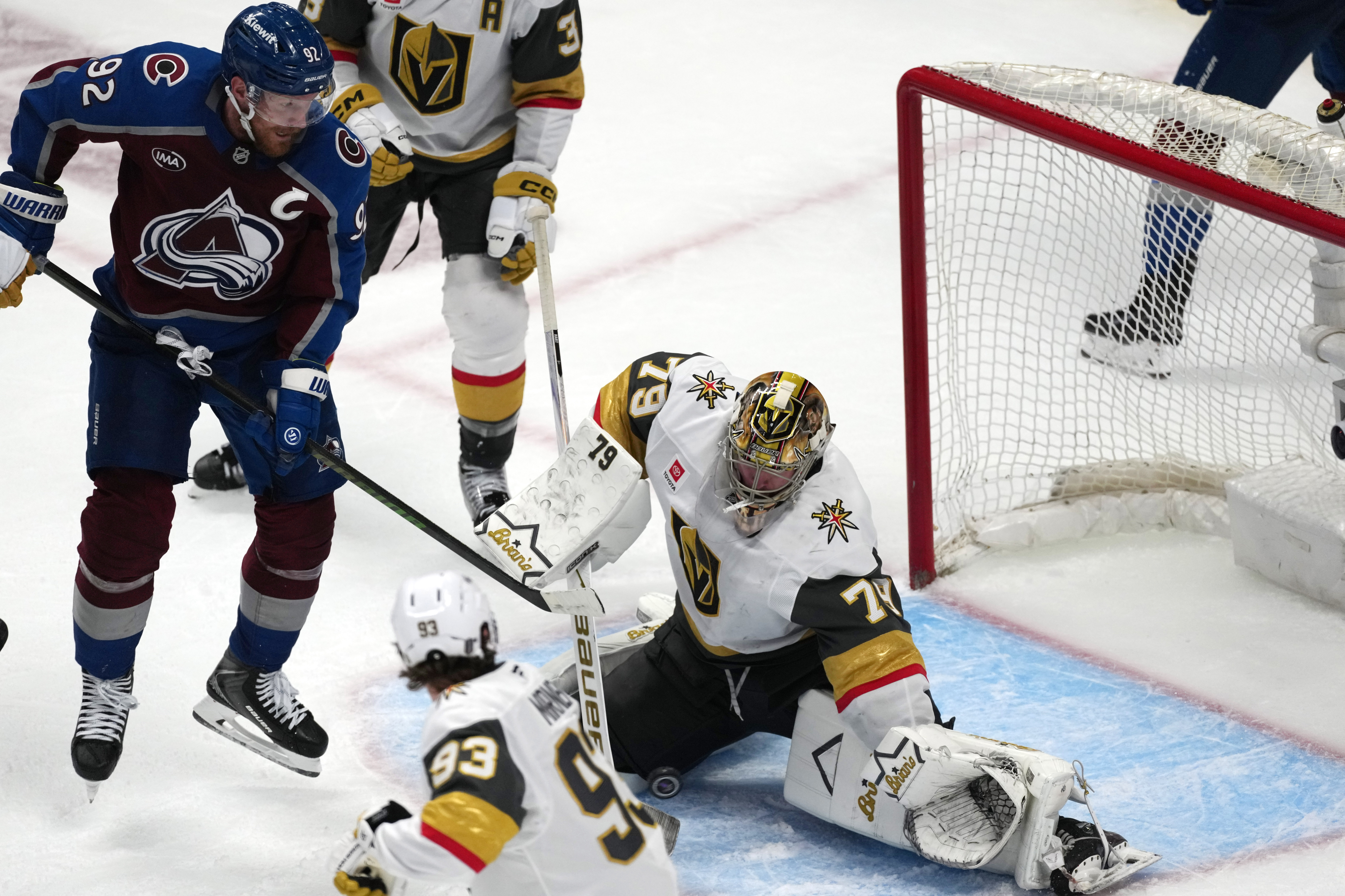 Vegas Golden Knights goaltender Carter Hart, right, stops a shot off the stick of Colorado Avalanche left wing Gabriel Landeskog during the third period in Game 1 of the Western Conference finals NHL hockey Stanley Cup playoff series Wednesday, May 20, 2026, in Denver. 