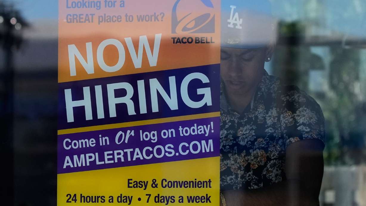 A hiring sign is displayed at a restaurant in Niles, Ill., May 14. Fewer Americans filed for jobless aid last week as layoffs remain low despite a number of uncertainties that continue to cloud the economy.