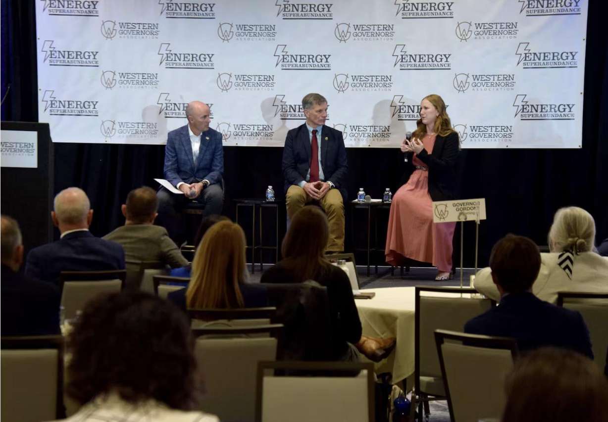 Utah Gov. Spencer Cox, Wyoming Gov. Mark Gordon and Executive Director of the Federal Permitting Improvement Steering Council Emily Domenech discuss permitting during a Western Governors Association panel in Salt Lake City on Wednesday.