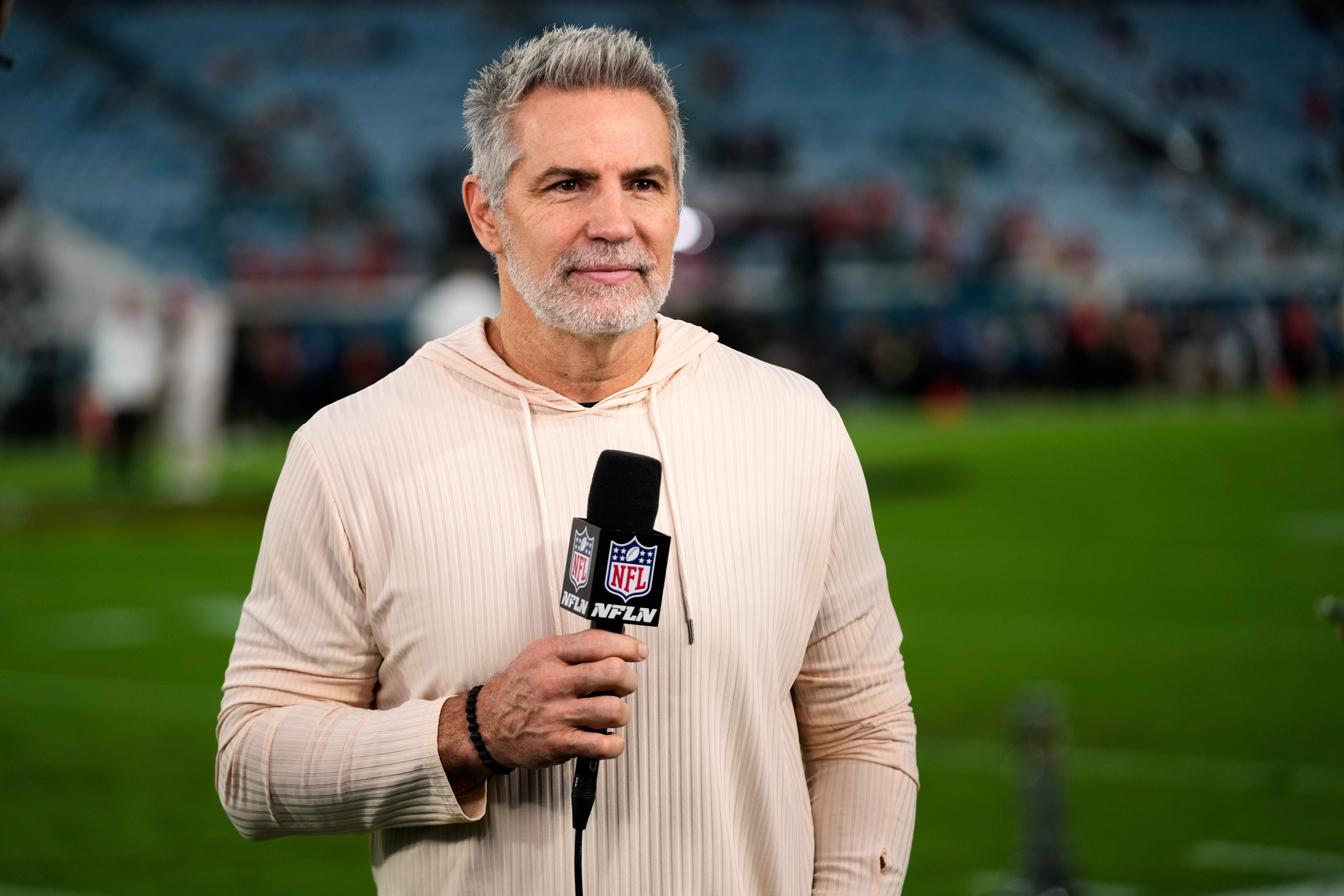 FILE - NFL Network analyst Kurt Warner reports before an NFL football game between the Jacksonville Jaguars and the Kansas City Chiefs, Oct. 6, 2025, in Jacksonville, Fla. 