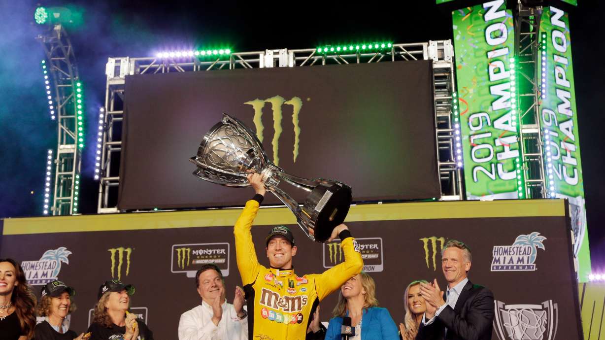 Kyle Busch holds up the then-Monster Energy NASCAR Cup Series trophy in victory lane after winning the season championship at Homestead-Miami Speedway in Homestead, Fla., Nov. 17, 2019. Busch died at the age of 41 on Thursday.