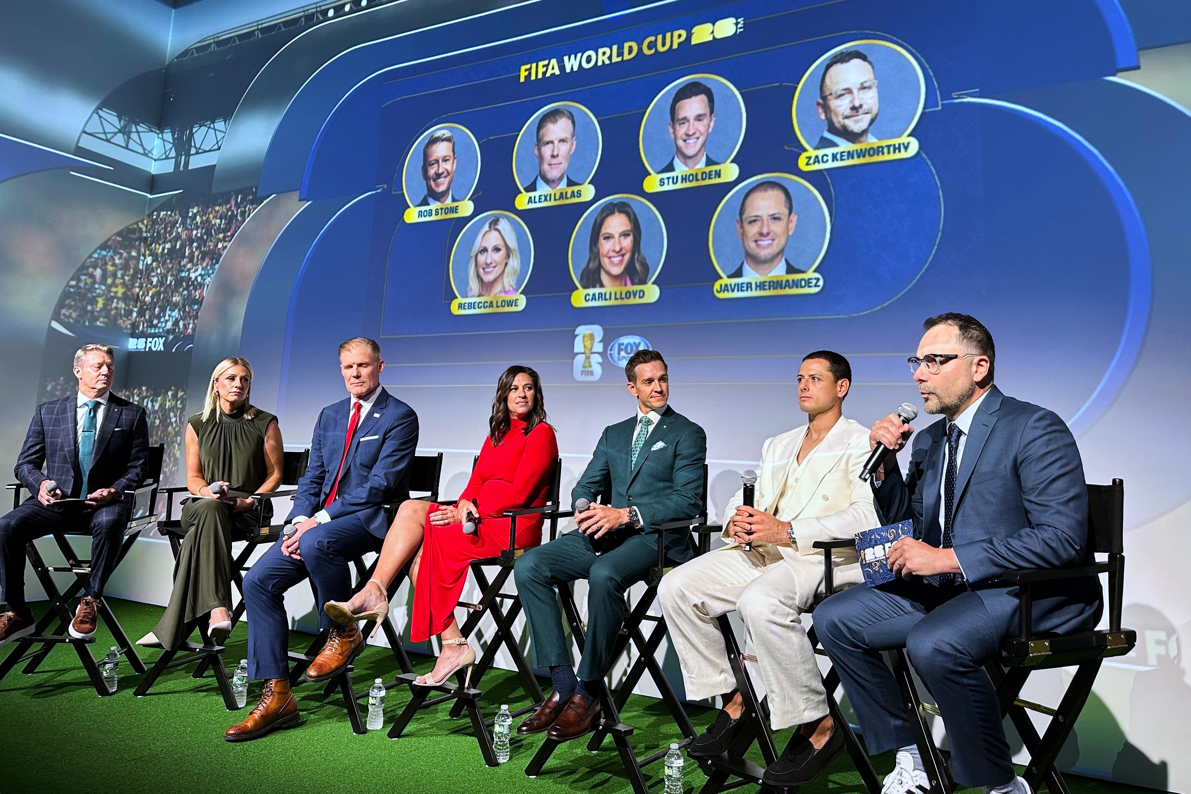Fox Sports hosts, from left, Rob Stone and Rebecca Lowe, and former player/analysts Alexi Lalas, Stu Holden and Javier Hernandez listen as Fox Sports' vice president of production Zac Kenworthy speaks during a World Cup soccer new conference, Thursday, May 21, 2026, in New York. 