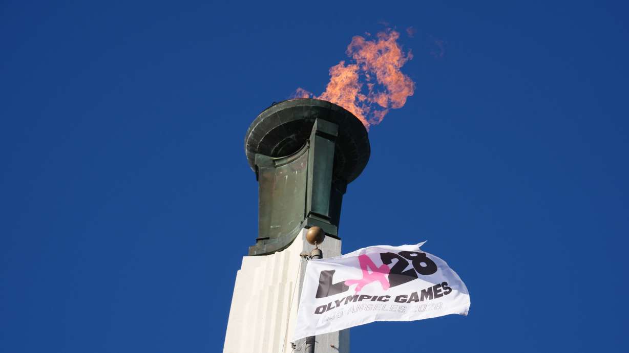 The Olympic cauldron is lit at the Los Angeles Memorial Coliseum on Jan. 13. Tickets may be costly after the City Council introduced a 10% tax on tickets to take effect next year.
