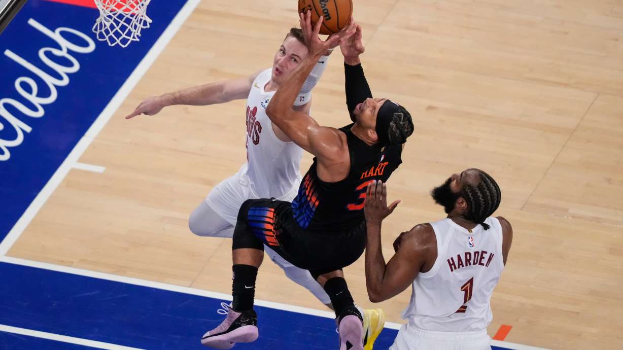 New York Knicks guard Josh Hart (3) is blocked by Cleveland Cavaliers guard Sam Merrill (5) during the second half of Game 2 in the Eastern Conference finals NBA basketball playoffs series, Thursday, May 21, 2026, in New York.