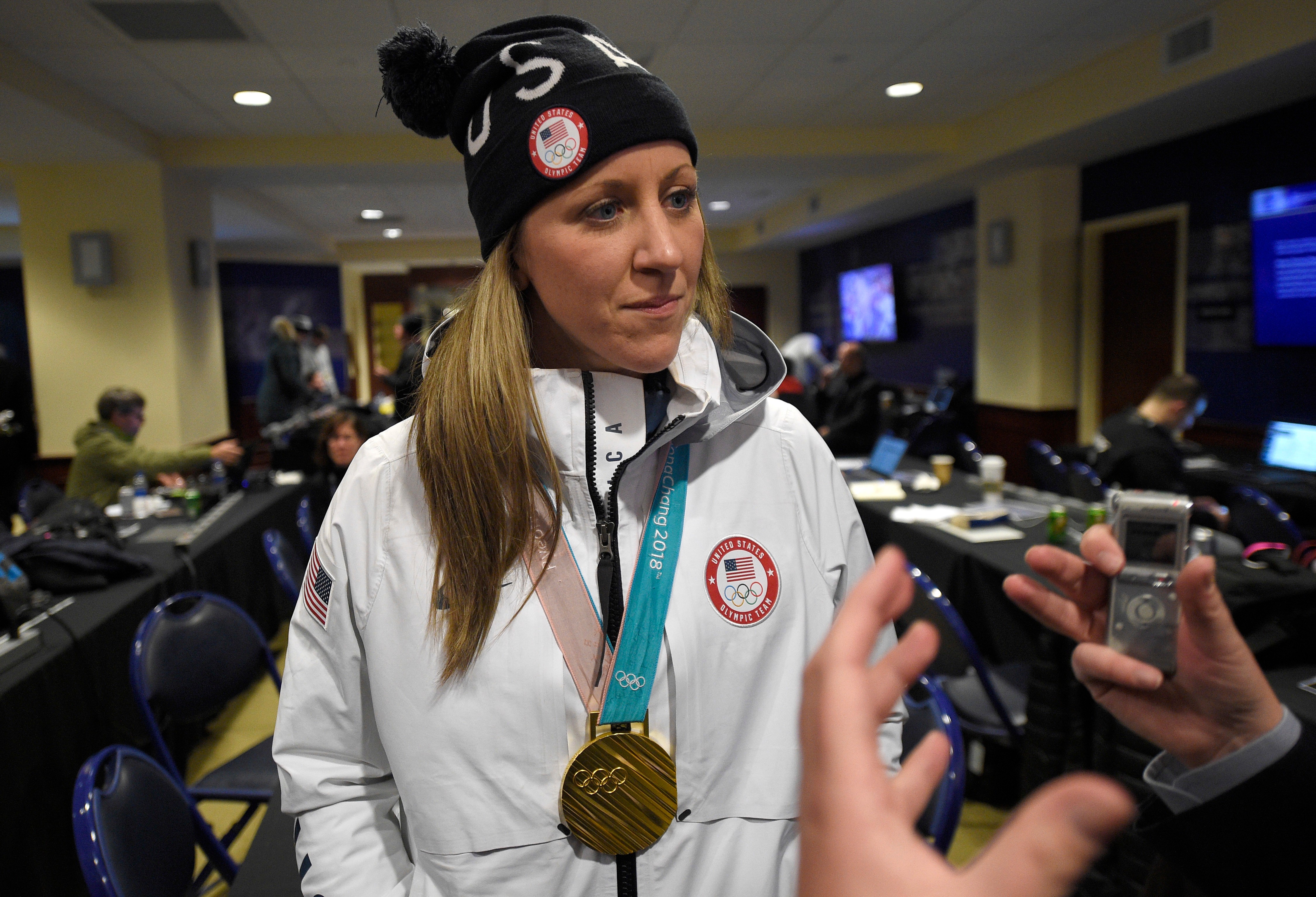 FILE - Meghan Duggan listens to a question from the media, March 3, 2018, in Annapolis, Md. 