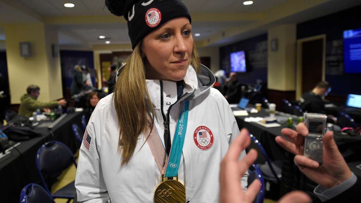 FILE - Meghan Duggan listens to a question from the media, March 3, 2018, in Annapolis, Md.