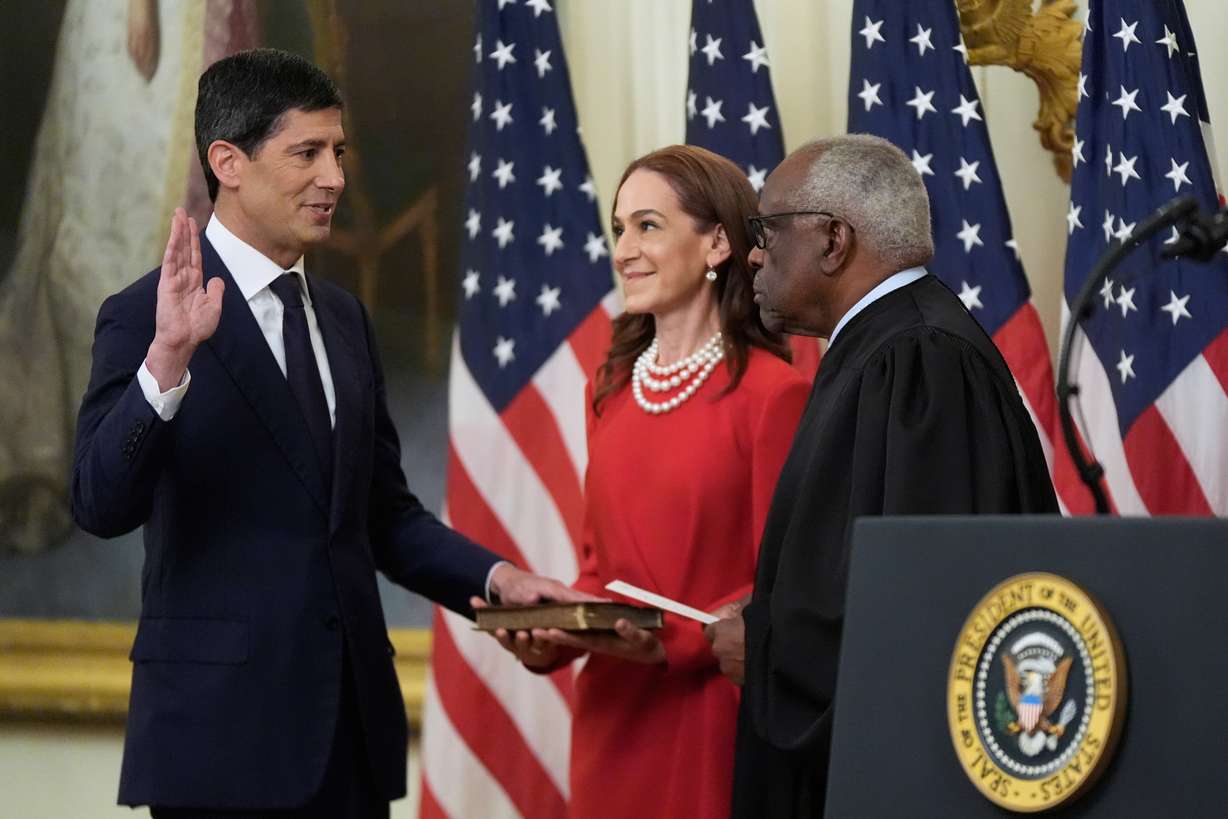 Supreme Court Justice Clarence Thomas administers the oath of office to Kevin Warsh as chair of the Federal Reserve in the East Room of the White House, Friday in Washington, as Warsh's wife, Jane Lauder, looks on. Warsh called it the "honor of a lifetime" to return to public service.