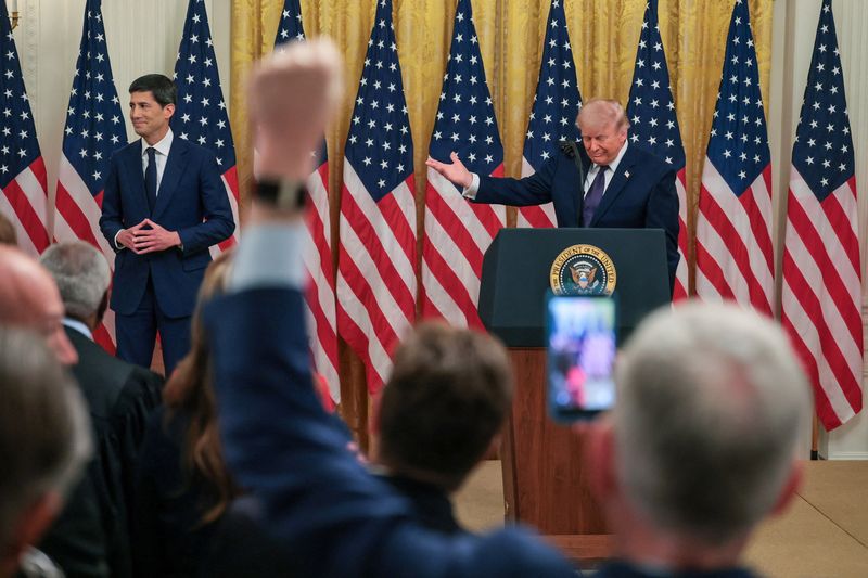 President Donald Trump gestures towards incoming Federal Reserve Chair Kevin Warsh at his swearing-in ceremony in the East Room of the White House in Washington, Friday. Trump said Warsh has his full support, but cautioned "growth does not mean inflation."