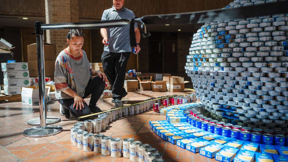 People put together a sculpture made from canned food at the Salt Lake County Government Center in Salt Lake City as part of the America 250 celebrations. Various displays can be seen at the county’s different public buildings.