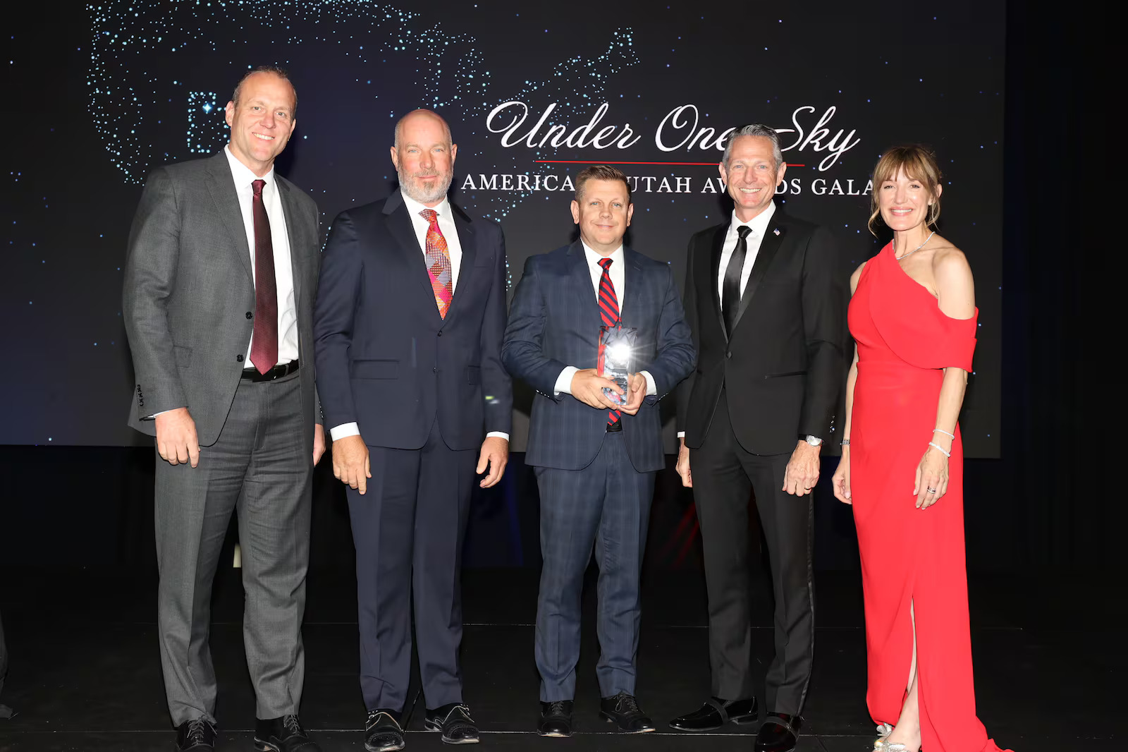 Steve Miller and Steve Starks accept the Under One Sky Award on behalf of the Larry H. Miller Company during the Salt Lake Chamber's "Under One Sky America 250 Utah Awards Gala" at Grand America on Thursday. The award honors an organization that consistently brings people together.