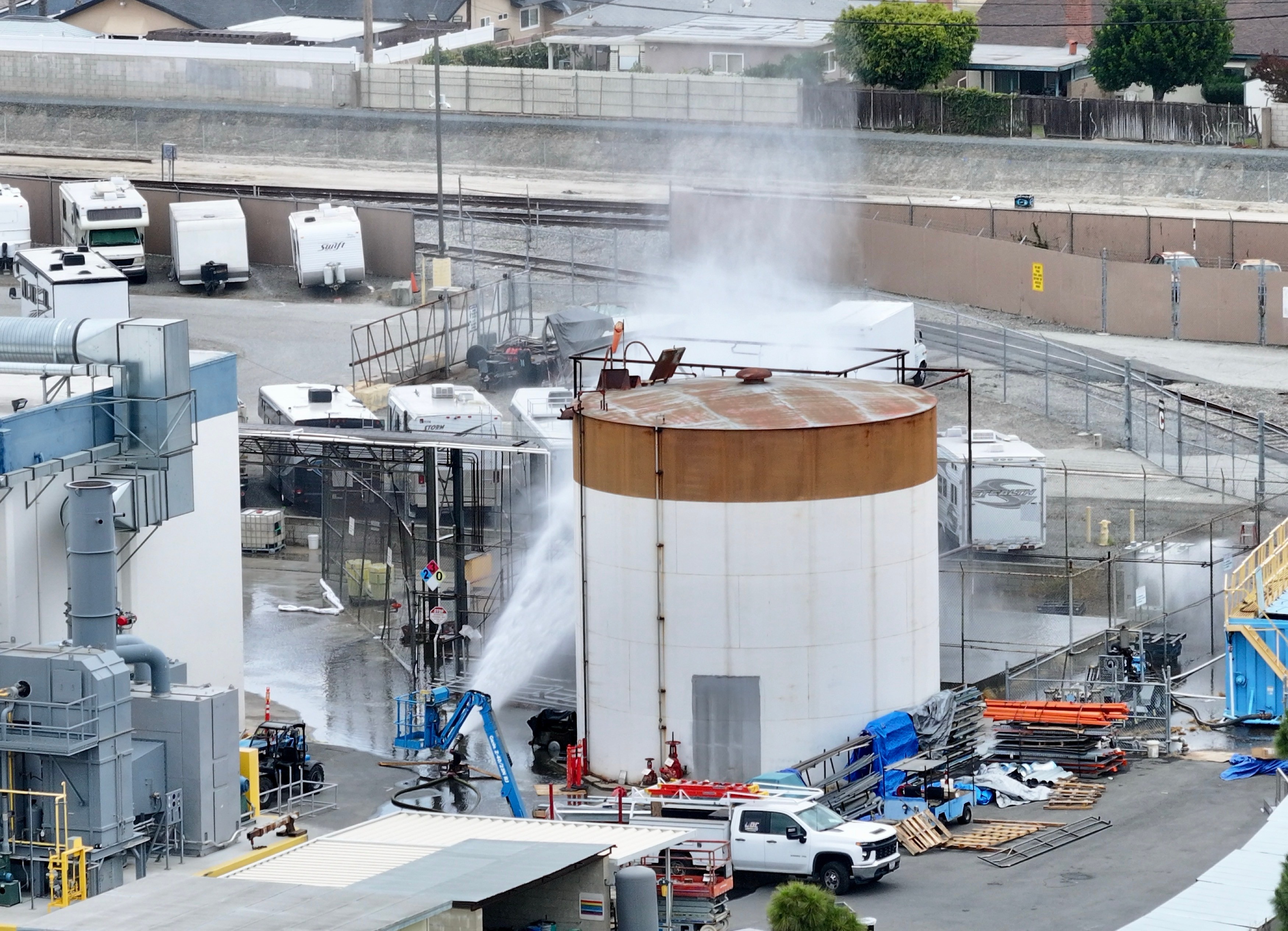 Water is sprayed on a tank that overheated at an aerospace plant in Garden Grove, Calif., Friday. Garden Grove Fire Chief Danny Covey said at a press conference that the tank would fail, but officials are searching for ways to either prevent it or figure out when it could fail.