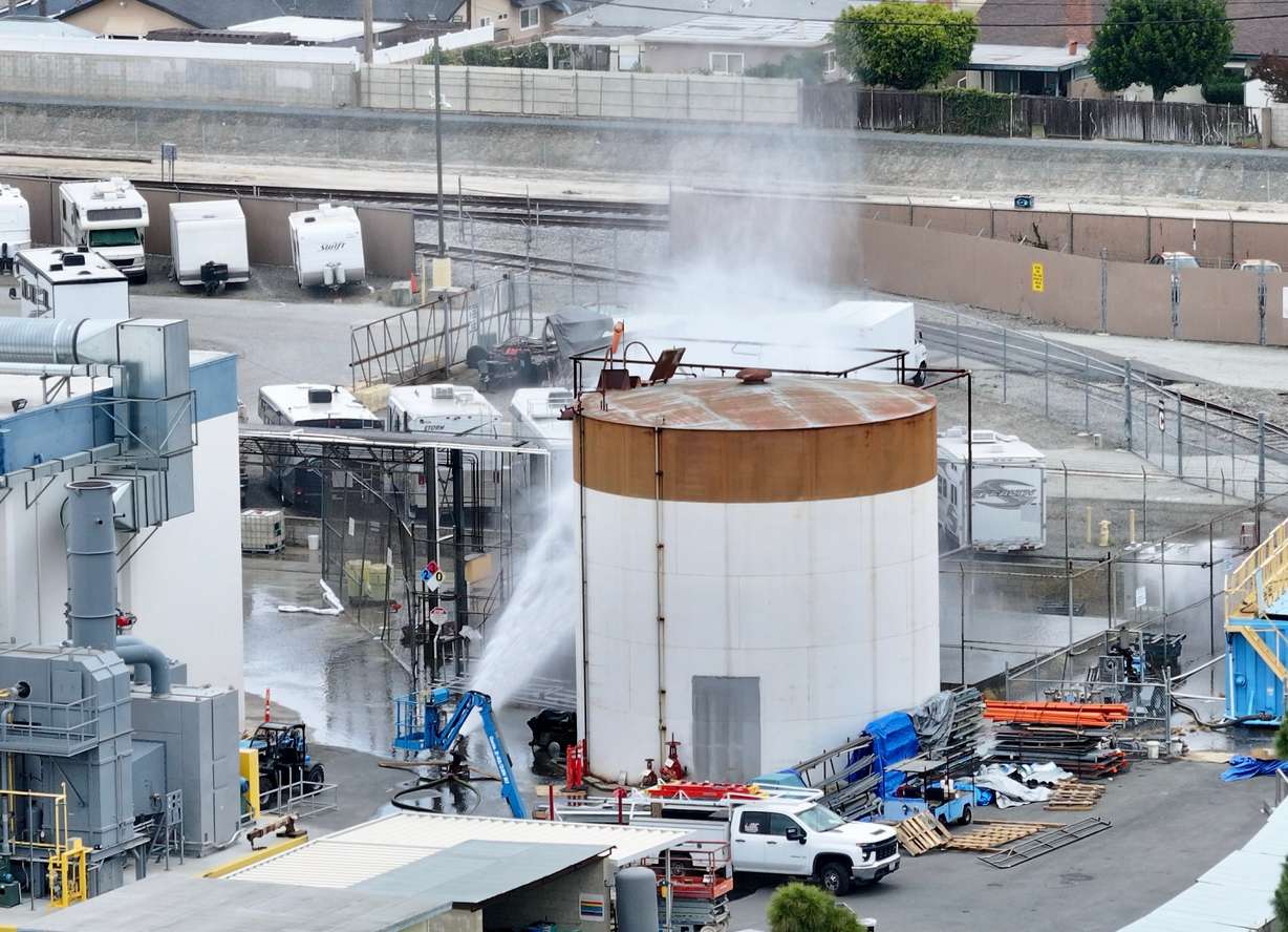 Water is sprayed on a tank that overheated at an aerospace plant in Garden Grove, Calif., Friday. Garden Grove Fire Chief Danny Covey said at a press conference that the tank would fail, but officials are searching for ways to either prevent it or figure out when it could fail.