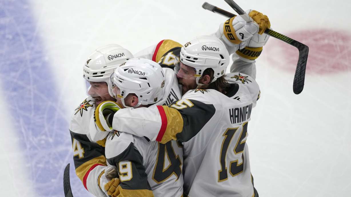 Vegas Golden Knights left wing Ivan Barbashev, center, is congratulated by Vegas Golden Knights defensemen Rasmus Andersson, left, and Noah Hanifin during the third period in Game 2 of the Western Conference finals NHL hockey Stanley Cup playoff series against the Colorado Avalanche Friday, May 22, 2026, in Denver.