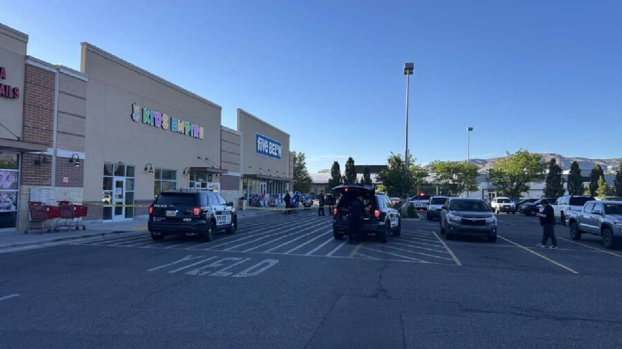 A woman is in custody after Salt Lake police say she shot her husband during a custodial dispute at Kids' Empire in Salt Lake City on Friday night.