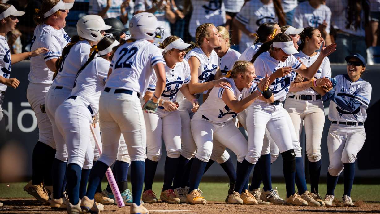 The Salem Hills Skyhawks react after Salem Hills Skyhawks' Emmery Wilson (22) scores a run during Game 1 of the 5A softball state championship against the Box Elder Bees at Gail Miller Field in Provo on Thursday, May 21, 2026.