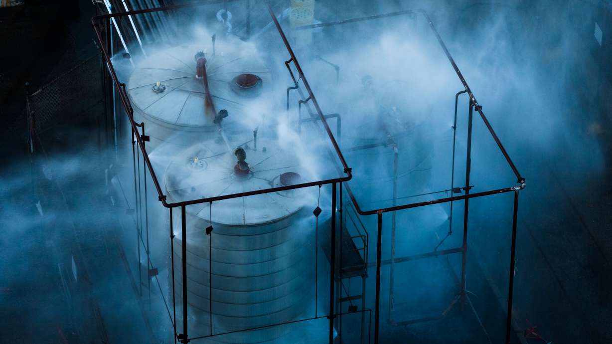 Water is sprayed on a tank that overheated at an aerospace plant in Garden Grove, Calif., Friday.