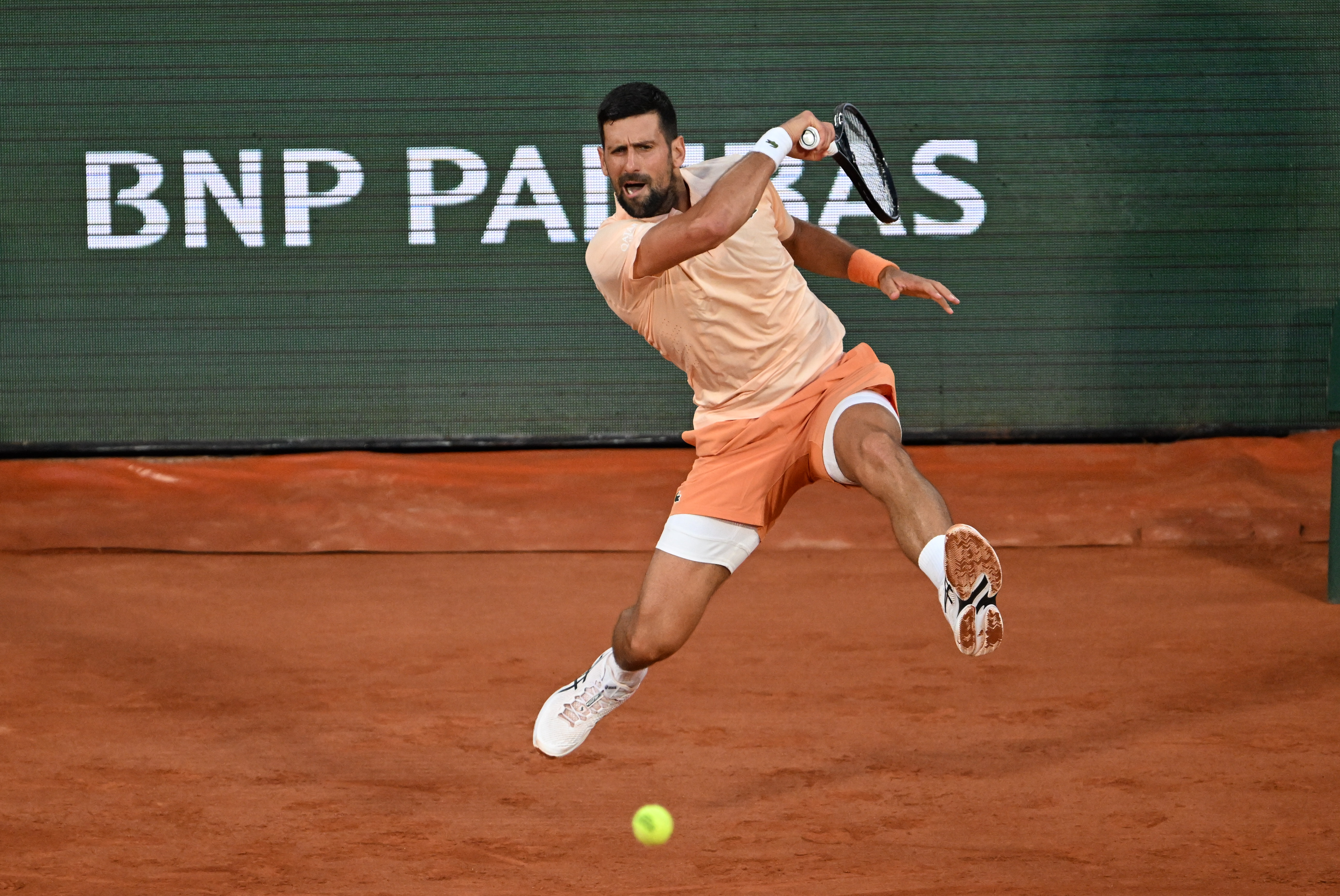 Novak Djokovic overcomes a slow start and hostile crowd in 1st-round win at French Open