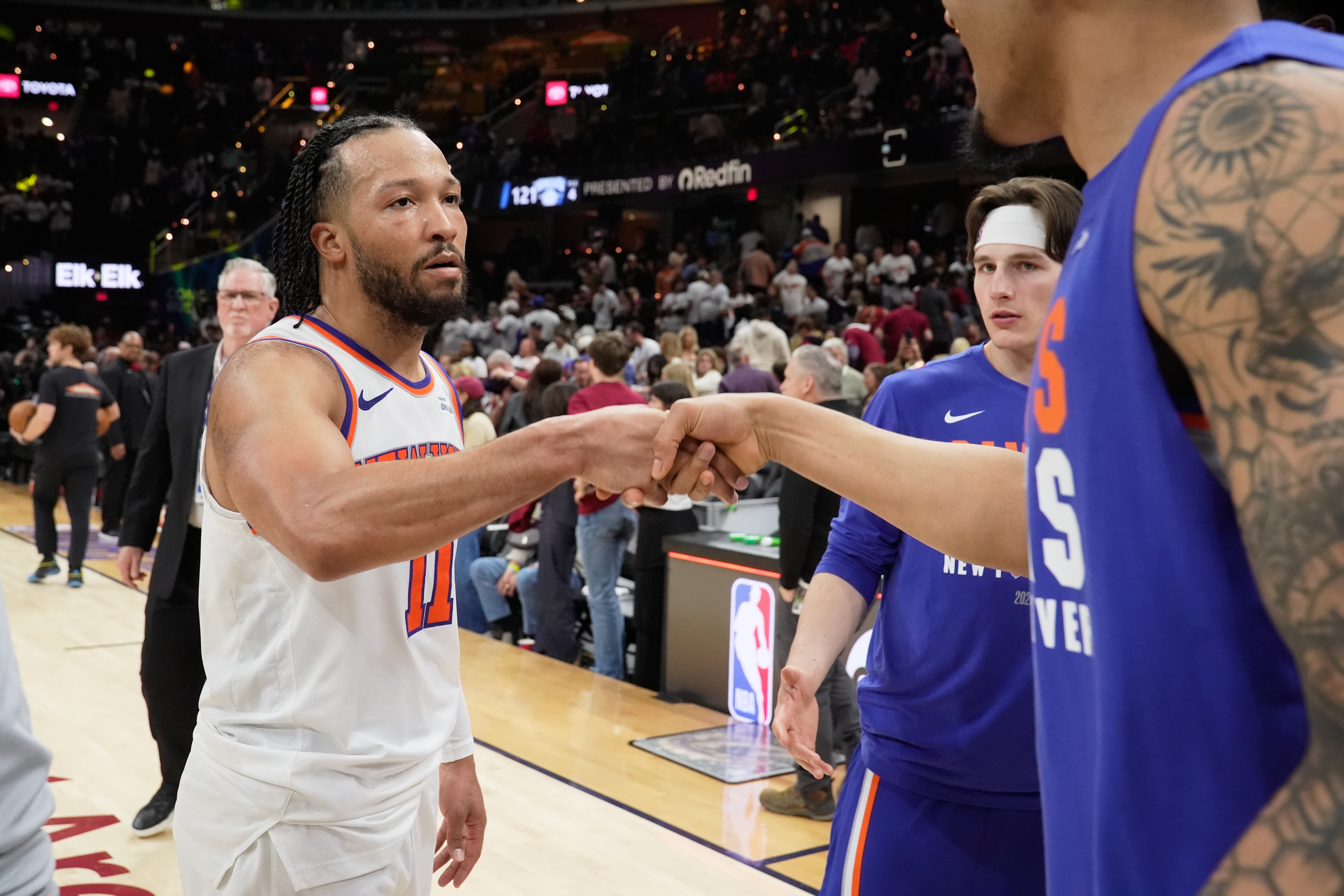 New York Knicks guard Jalen Brunson (11) celebrates with teammates after winning Game 3 in the Eastern Conference finals NBA basketball playoffs series against the Cleveland Cavaliers in Cleveland, Saturday, May 23, 2026. 