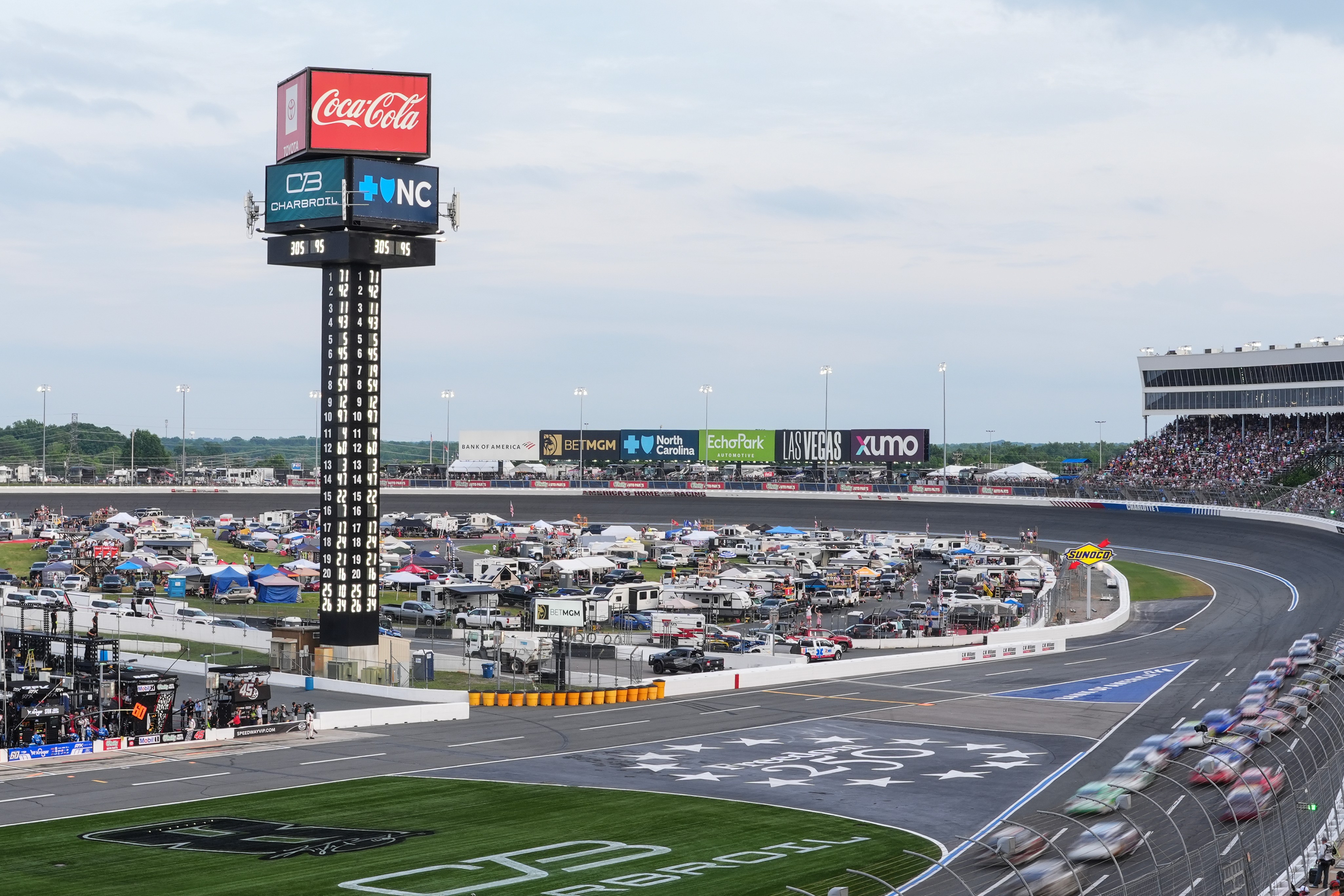 A pack of cars compete down the front stretch during a NASCAR Cup Series auto race, Sunday, May 24, 2026, in Charlotte, N.C. 