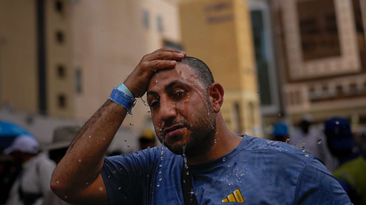 A Muslim pilgrim splashes water over his head to cool down outside the Grand Mosque during the annual hajj pilgrimage at the holy city of Mecca, Saudi Arabia, Sunday. The pilgrimage started Monday against the backdrop of regional tensions.