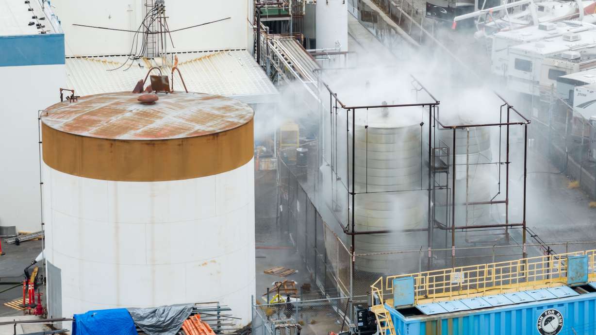 Water is sprayed on a damaged tank at GKN Aerospace in Garden Grove, Calif., on Sunday, after the tank containing a chemical used to make plastic parts overheated on Thursday.