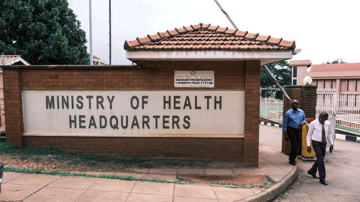 People walk out of the Ministry of Health's Headquarters in Kampala, Uganda, on May 19.