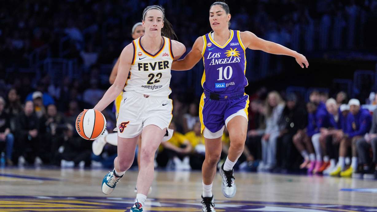 Los Angeles Sparks guard Kelsey Plum (10) pressures Indiana Fever guard Caitlin Clark (22) during the first half of a WNBA basketball game Wednesday, May 13, 2026, in Los Angeles.