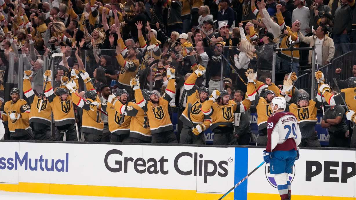 Members of the against the Vegas Golden Knights celebrate an empty net goal by Brett Howden as Colorado Avalanche center Nathan MacKinnon skates by during the third period in Game 3 of the Western Conference finals NHL hockey Stanley Cup playoff series Sunday, May 24, 2026, in Las Vegas.