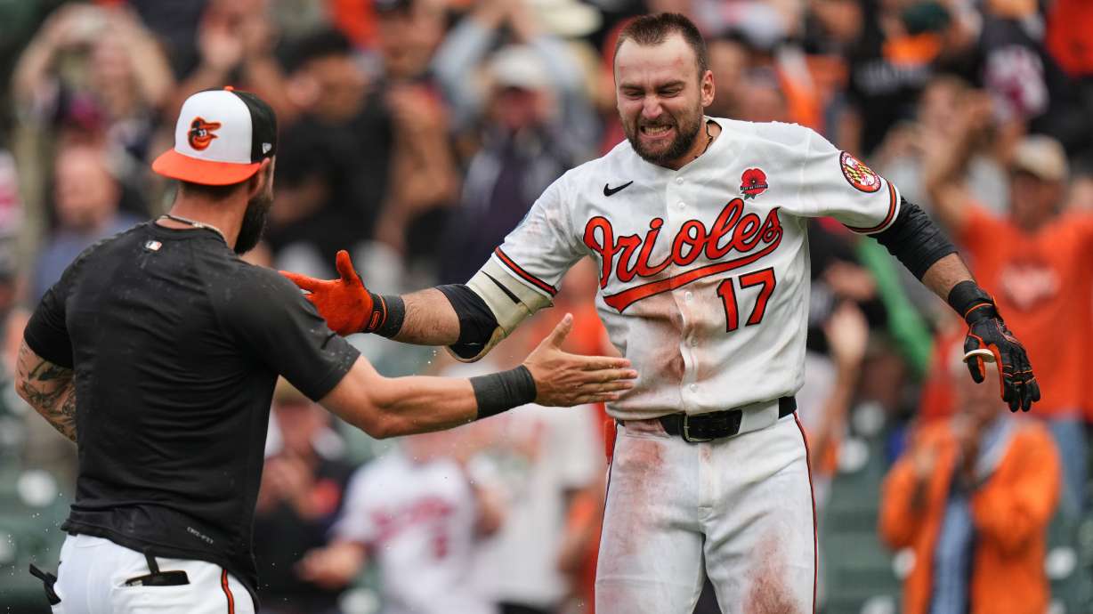 Baltimore Orioles' Colton Cowser, right, celebrates with teammates after hitting a walk off two-run home run during the 13th inning of a baseball game against the Tampa Bay Rays, Monday, May 25, 2026, in Baltimore.