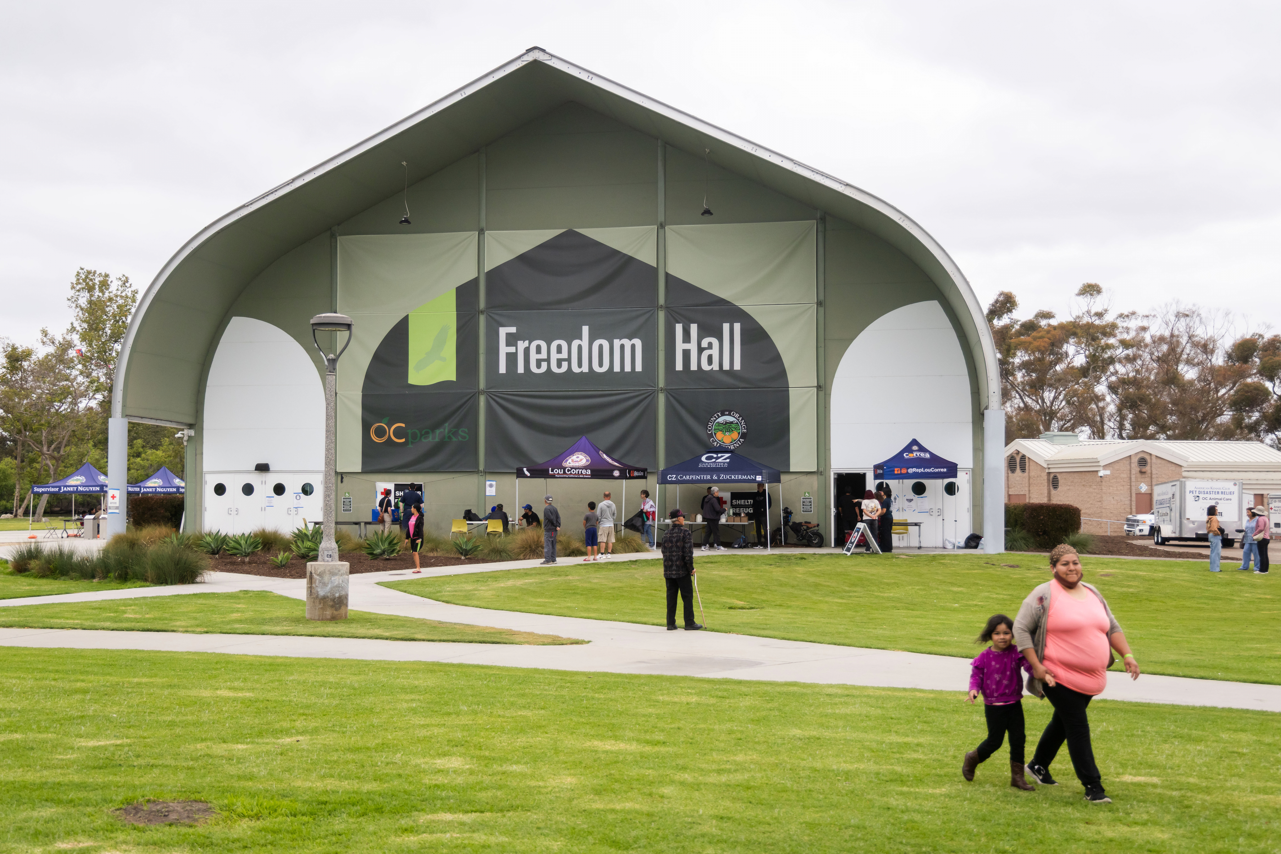 People walk outside Freedom Hall, an evacuation center in Fountain Valley, Calif., on Monday. Officials lifted evacuation orders near a damaged chemical tank, which forced 50,000 people from their homes.