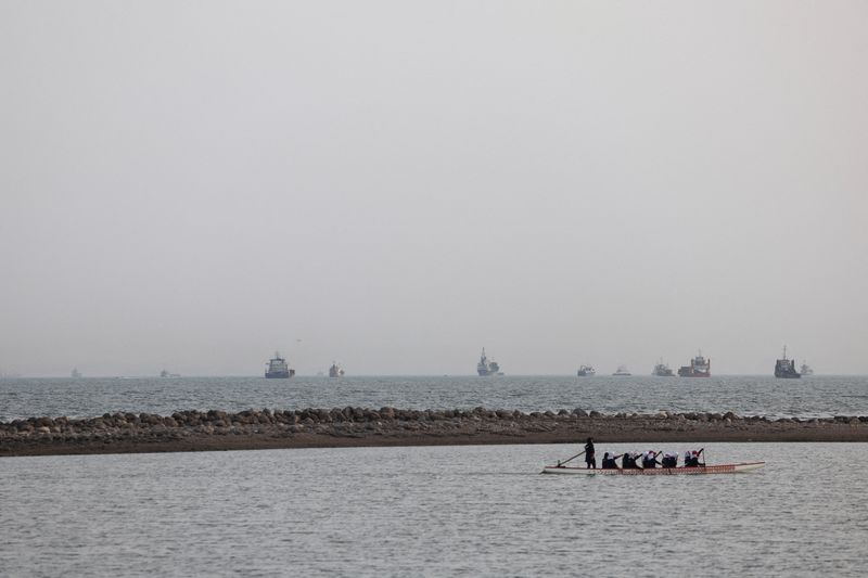 Vessels in the Strait of Hormuz are visible near the beach of Bandar Abbas, Iran, Friday. The U.S. launched fresh strikes against Iran on Monday as talks to end the war continued.