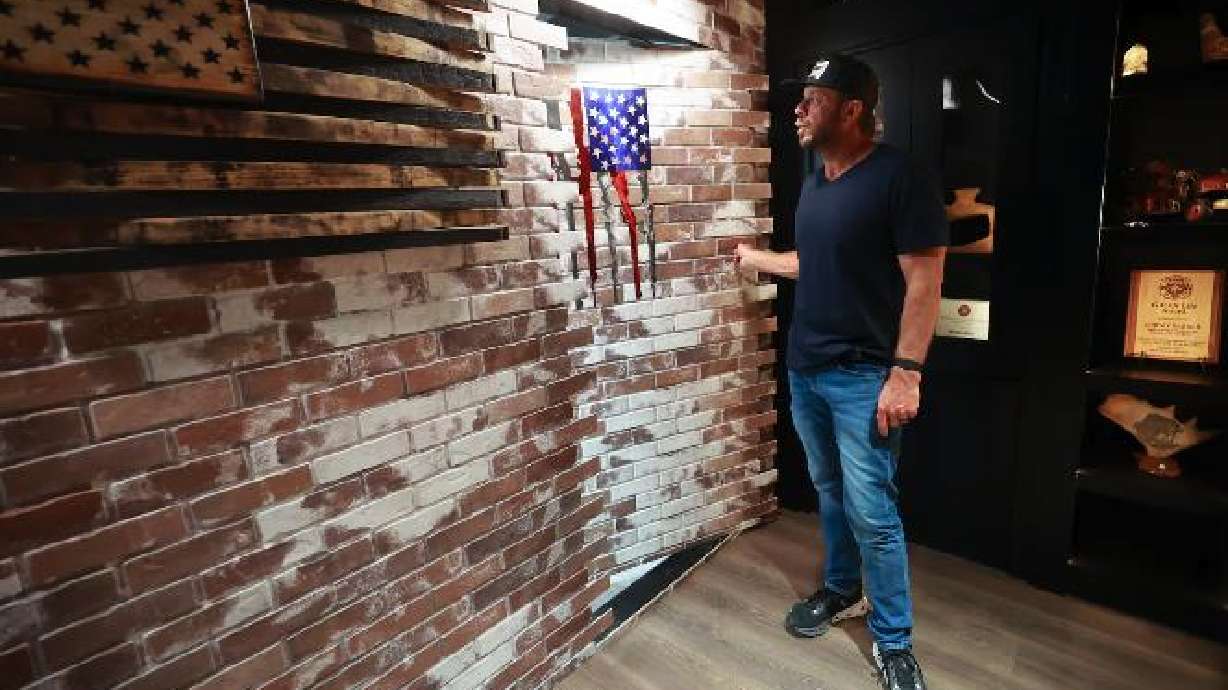 Jeremy Barker, Murphy Door CEO, shows a hidden Murphy Door in a speakeasy room at Murphy Door in Ogden on May 13.