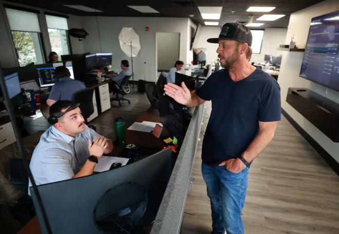 Xavier Haro, Murphy Door business account executive, and Jeremy Barker, Murphy Door CEO, talk at Murphy Door in Ogden on May 13.