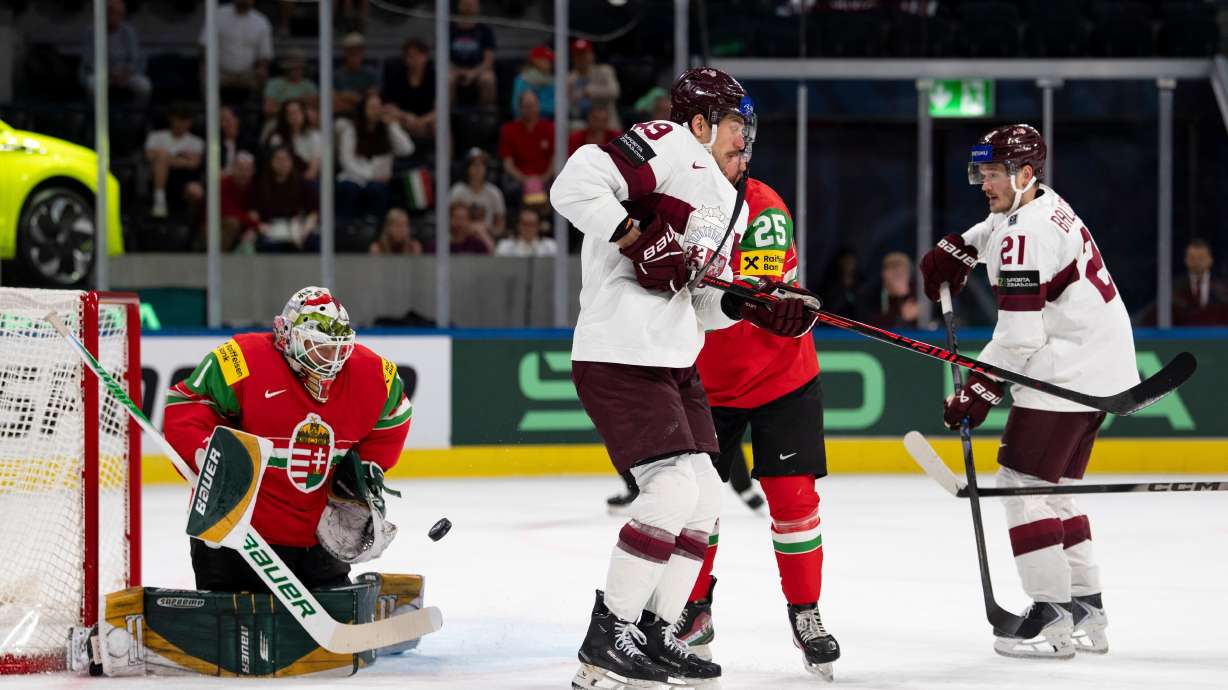 From left: Hungary's goaltender Bence Balizs, Latvia's Filips Buncis, Hungary's Gabor Tornyai and Latvia's Rudolfs Balcers fight for the puck during the 2026 IIHF Men's Ice Hockey World Championship preliminary round group A game between Hungary and Latvia, in Zurich, Switzerland, Tuesday, May 26, 2026.