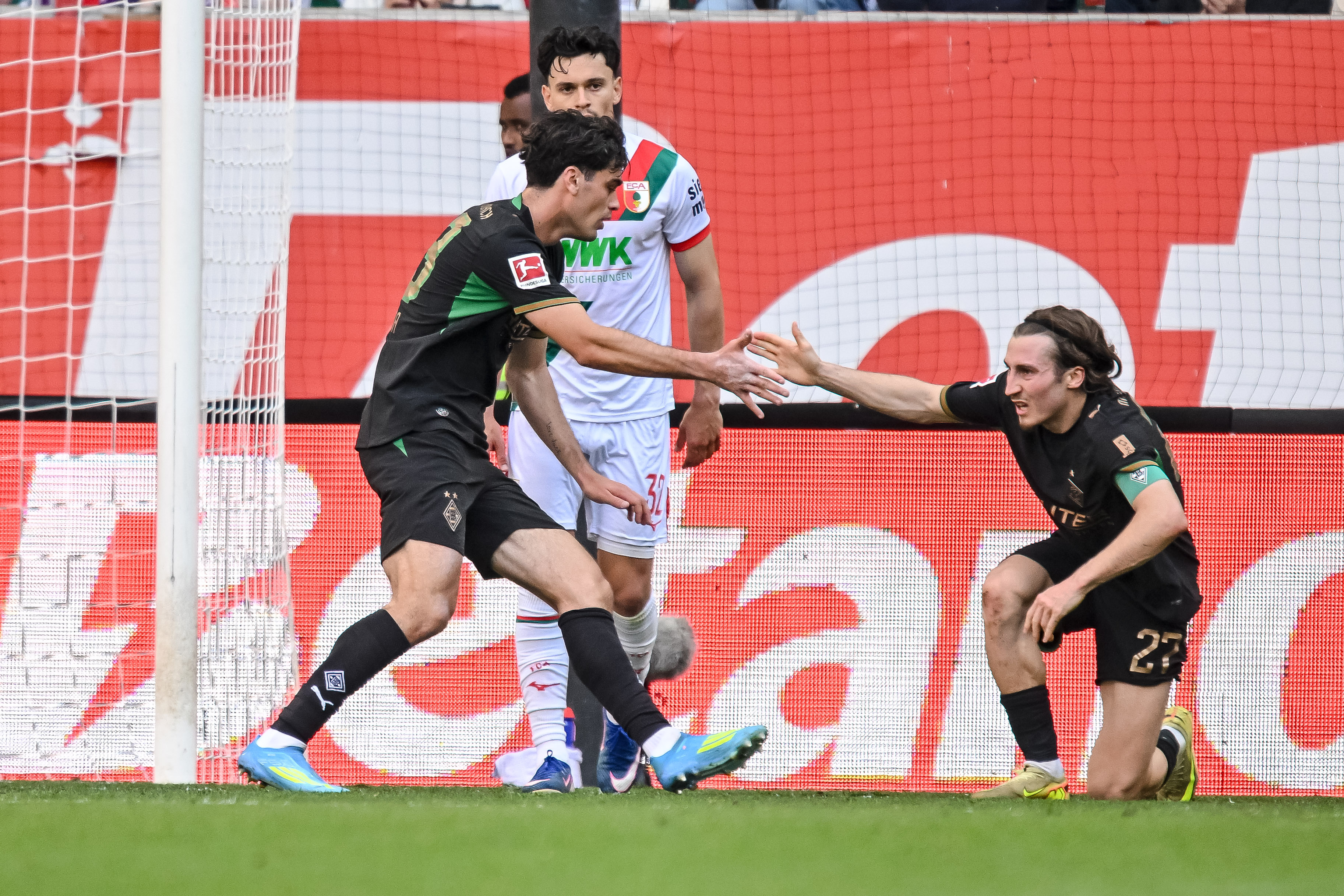 Moenchengladbach's Gio Reyna and Rocco Reitz high-five after the Reyna made a goal during a German Bundesliga soccer match between Borussia Moenchengladbach and FC Augsburg on Saturday, May 9, 2026, in Augsburg, Germany.