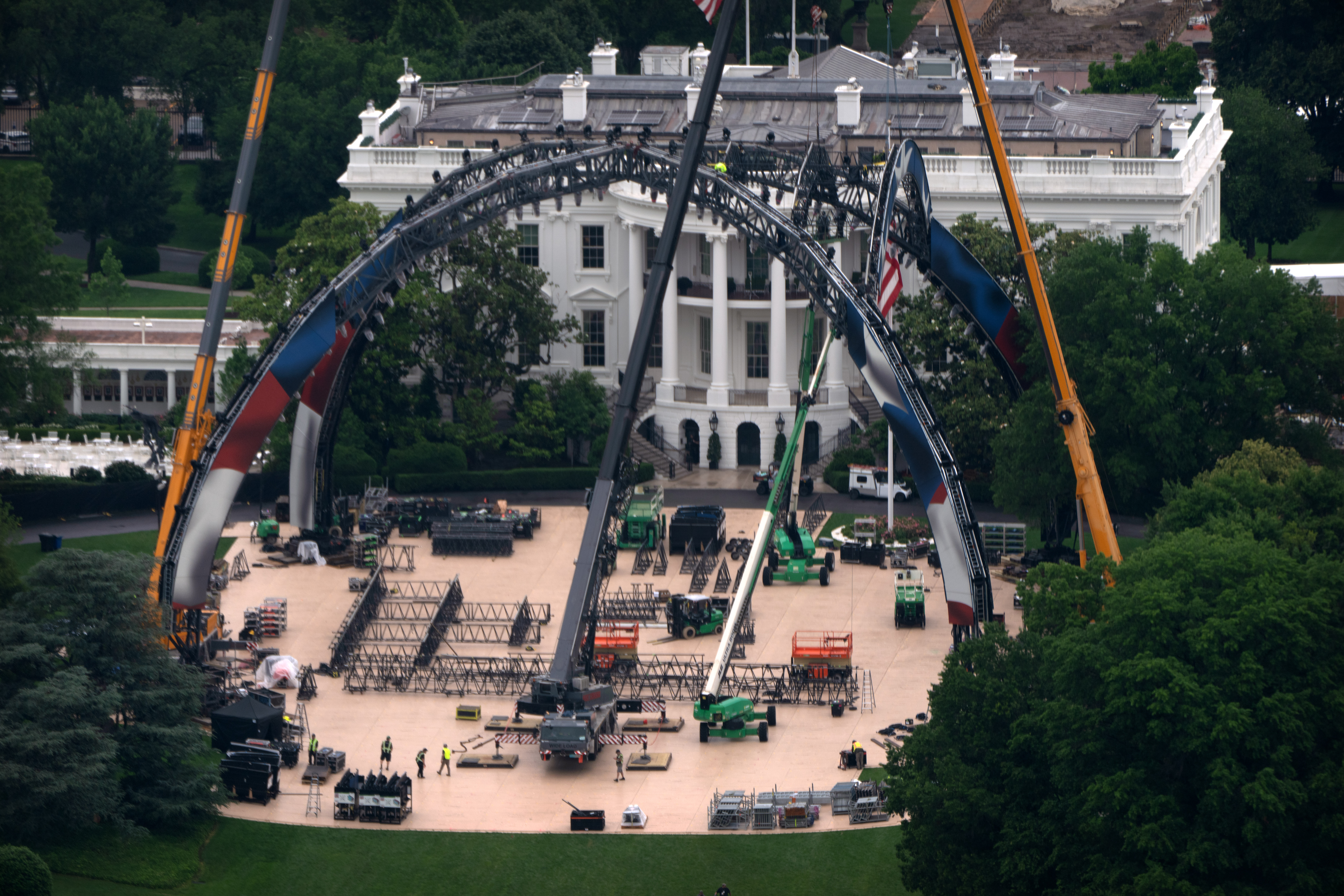 Equipment being placed on the South Lawn of the White House is seen from the Washington Monument, Tuesday, May 26, 2026, in Washington. The UFC is holding a mixed martial arts fight on June 14 as part of America 250 celebrations. 
