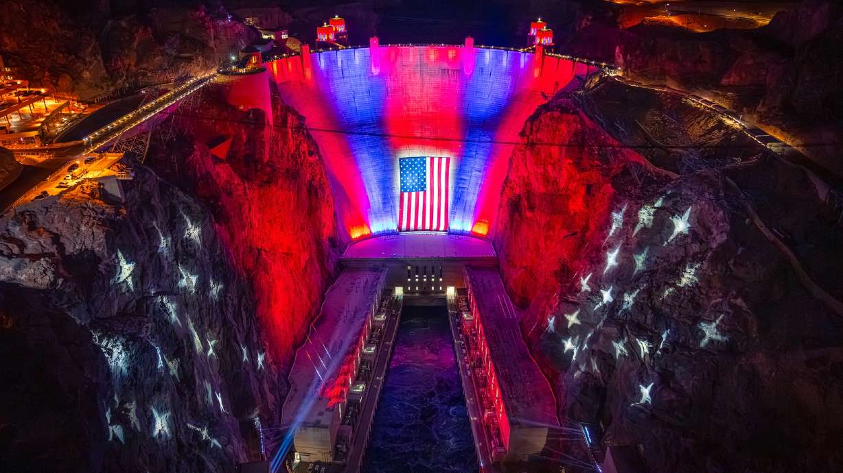 The Hoover Dam is lit up in red, white and blue with a 300-foot-wide and 150-foot-tall American flag at the center on Monday. The display will be in place every night through July 4, depending on weather.