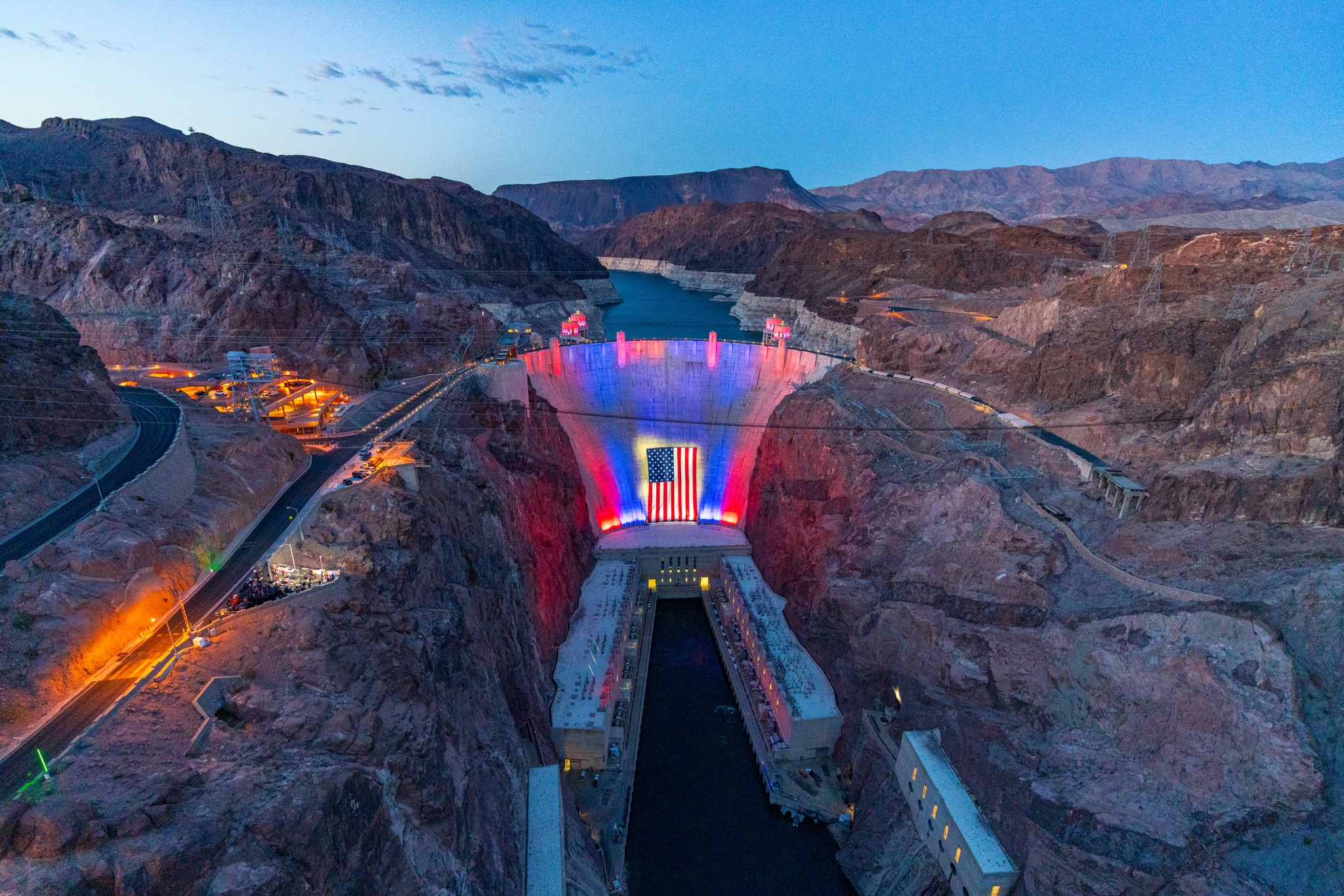 The Hoover Dam is lit up in red, white and blue with a 300-foot-wide and 150-foot-tall American flag at the center on Monday. Weather depending, the display will be in place every night through July 4.