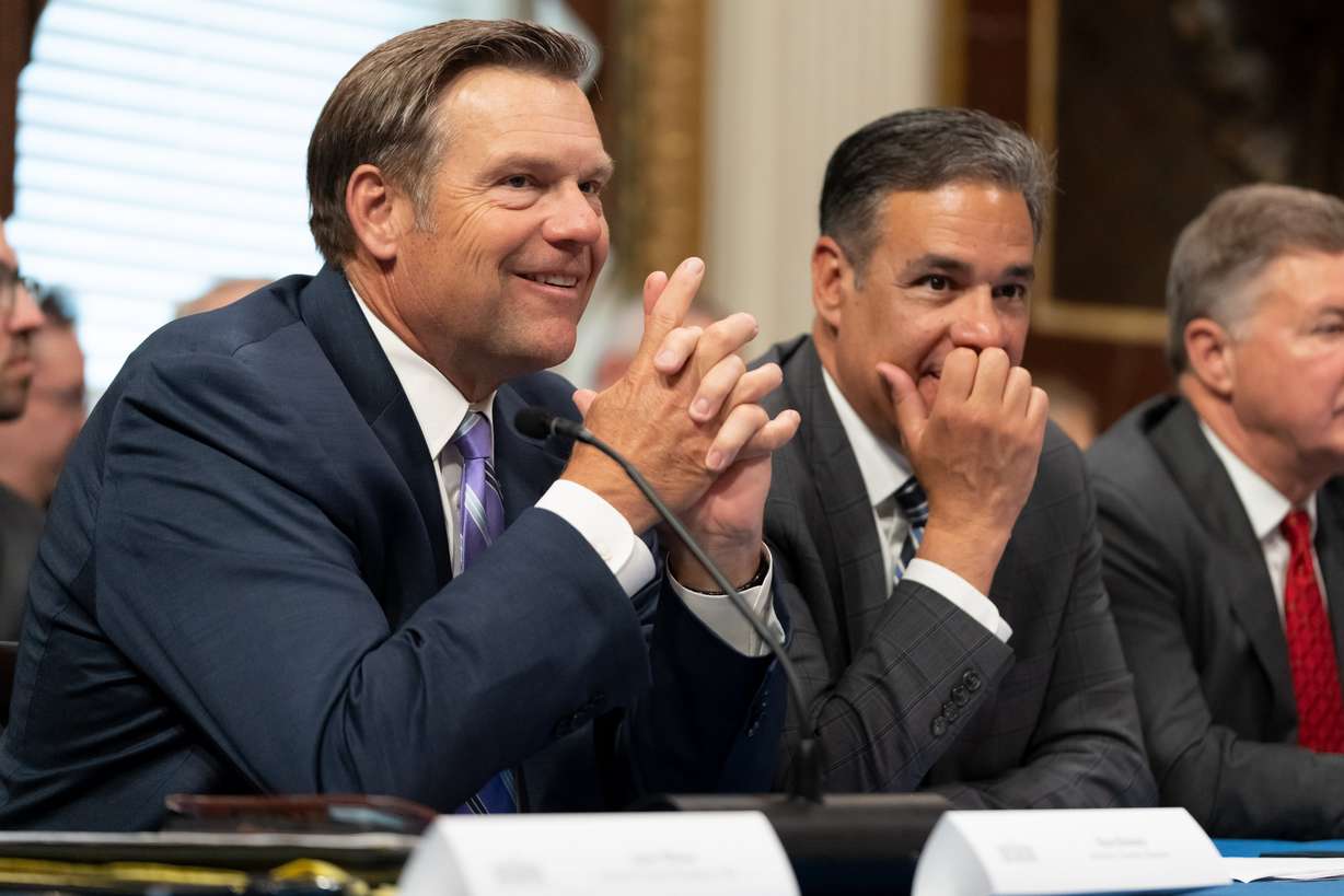 Kansas Attorney General Kris Kobach talks with Idaho Attorney General Raul Labrador before an event with Vice President JD Vance in the Eisenhower Executive Office Building, Tuesday, in Washington. Only two Democratic attorneys general were present at the event, citing short notice.