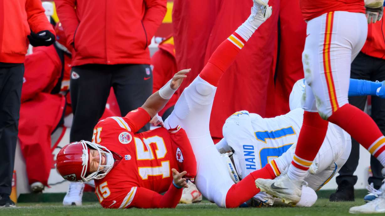 FILE - Kansas City Chiefs quarterback Patrick Mahomes (15) is injured while being tackled by Los Angeles Chargers defensive tackle Da'Shawn Hand (91) during the second half of an NFL football game, Dec. 14, 2025 in Kansas City, Mo.